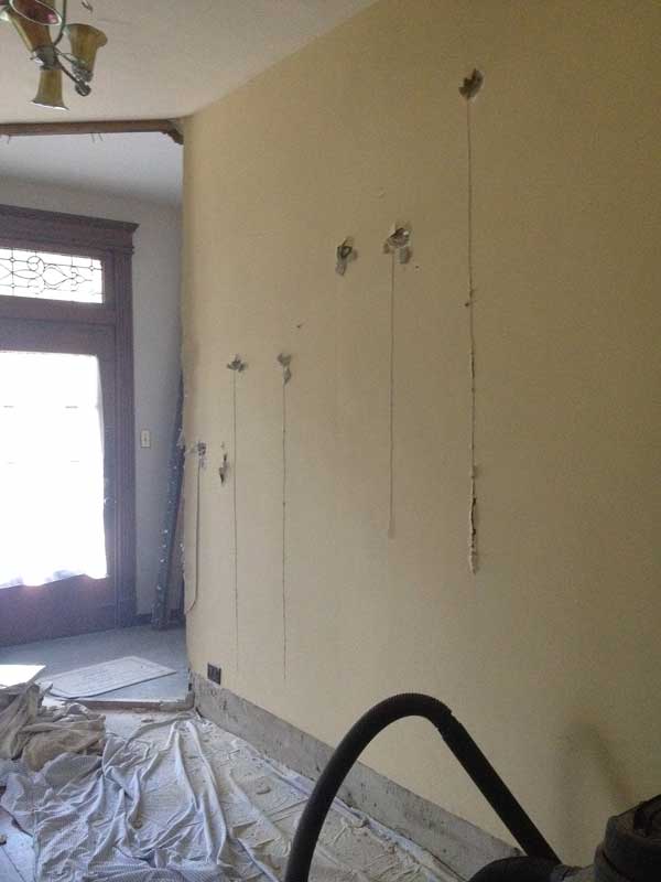 Step 2: Reciprocating saw cuts along the studs through the backside. Realize I'm going to need more dropcloths.